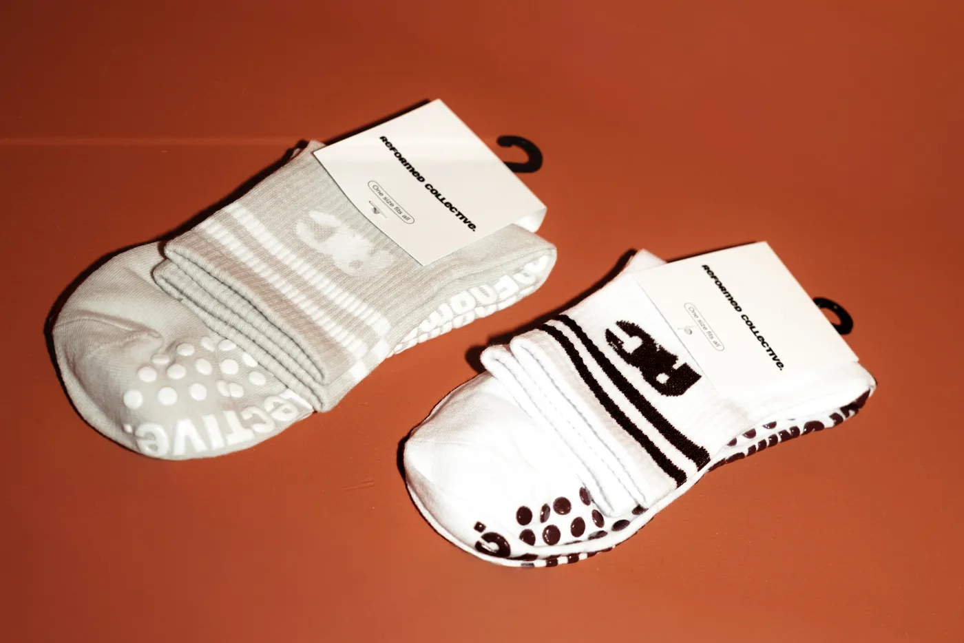Twee paar Reformed Collective gripsokken met RC-logo en antislip noppen onder de zool